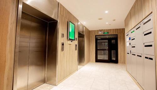 a hallway with a metal elevator in a building at Hanting Hotel Xinyang Railway Station in Xinyang