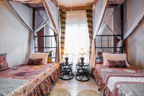 Postel nebo postele na pokoji v ubytování JET VILLAS ENTEBBE ( JVE )