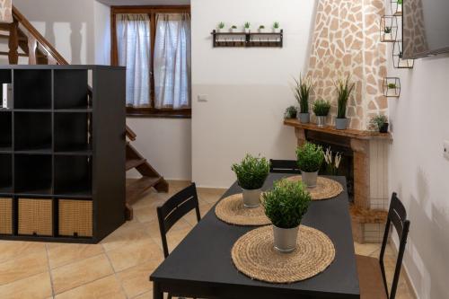 a dining room with two tables with plants on them at Suite Gli Ulivi in Colonna