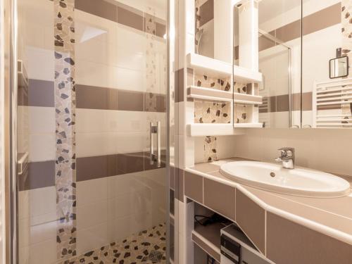 a white bathroom with a sink and a shower at Appartement La Clusaz, 2 pièces, 4 personnes - FR-1-304-181 in La Clusaz