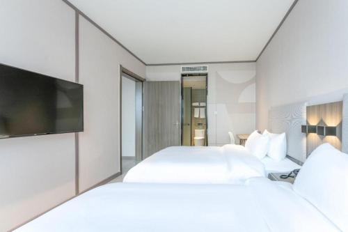 Cama o camas de una habitación en Hanting Hotel Yichun Economic Development Zone