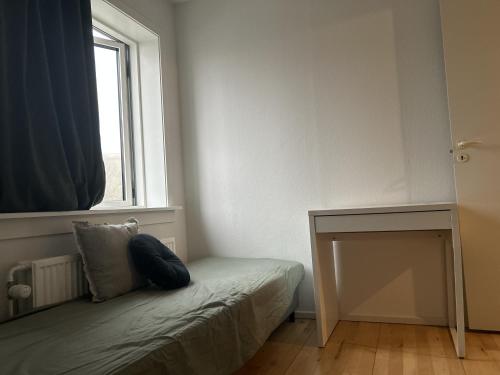 a small room with a bed and a window at 2 room and 1 living room charming family-friendly places in Copenhagen