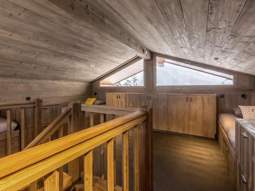 Habitación con paredes de madera y escalera en una cabaña. en Chalet 5* calme, cocon raffiné, 12 pers, vue montagne, WIFI, garage - FR-1-304-211, en La Clusaz