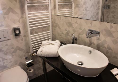 a bathroom with a sink and a toilet at Hotel Esprit in Prague