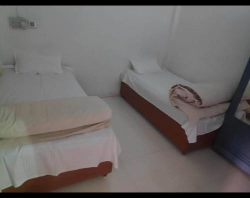 a room with two beds in a room at Home Stay - PG in Indore