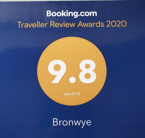 a yellow circle with the words travel review awards and brownive at Bronwye in Builth Wells