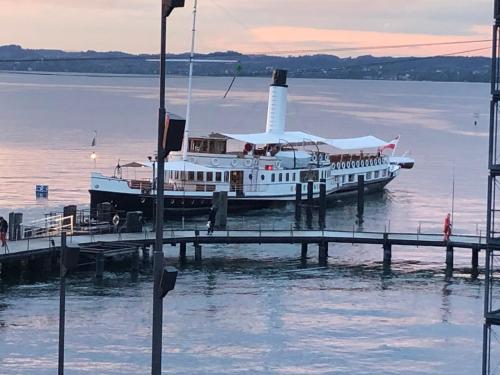 a ferry boat is docked at a dock at Ferienwohnung am Bodensee - Ruhe,Natur und Golfgenuss in Lochau