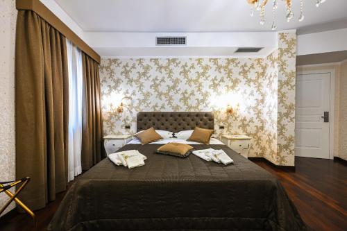 a bedroom with a large bed with two pillows on it at Hotel Mastrodattia in Celano