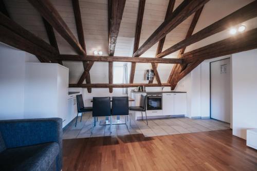a living room with wooden ceilings and a table and chairs at Design Hotel & Restaurant Löwen in Ulm