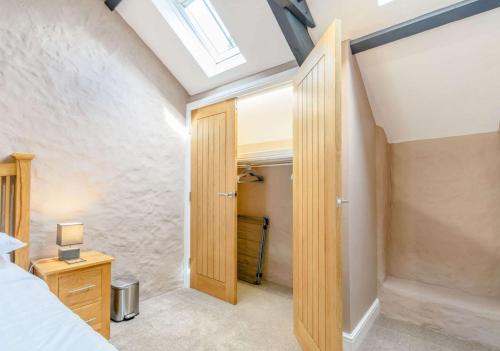 a bedroom with a door leading to a closet at Stable Cottage in Pembroke