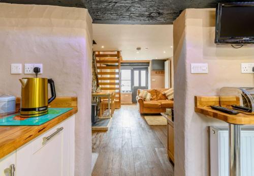 a kitchen and living room in a tiny house at Stable Cottage in Pembroke