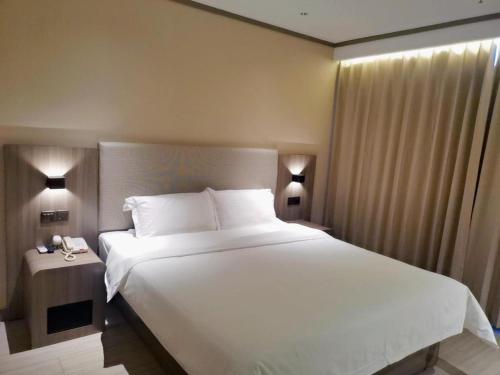 Krevet ili kreveti u jedinici u okviru objekta Hanting Hotel Baoding Sanfeng Road Farm