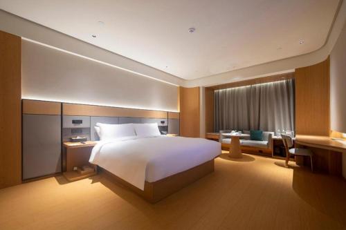 Un pat sau paturi într-o cameră la Ji Hotel Changde Hunan Wenli College