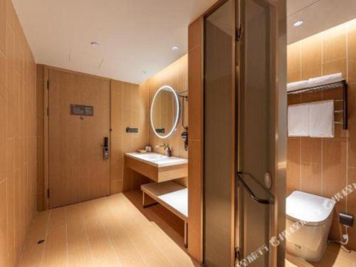 a bathroom with a sink and a mirror at JI Hotel Lanzhou University Donggang West Road in Baidaoping