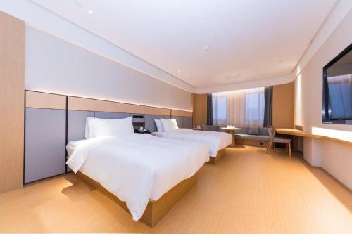 En eller flere senger på et rom på Ji Hotel Huzhou Changxing