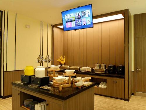 Una televisión o centro de entretenimiento en Hanting Hotel Cixian Yizhong