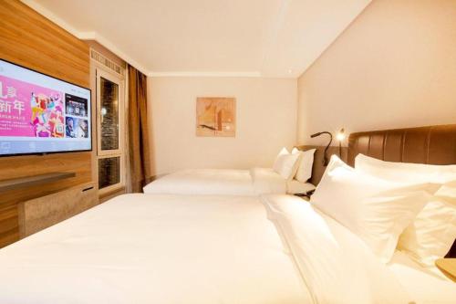 Säng eller sängar i ett rum på Hanting Premium Hotel Changchun Hongqi Street Wanda