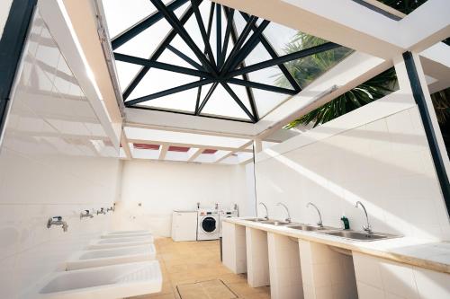 an attic bathroom with sinks and a skylight at Kampaoh Lago de Arcos in Arcos de la Frontera