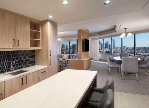 a kitchen and dining room with a view of the city at Hilton Anatole in Dallas