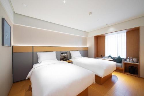 Posteľ alebo postele v izbe v ubytovaní Ji Hotel Changchun Xintiandi Changchun Street
