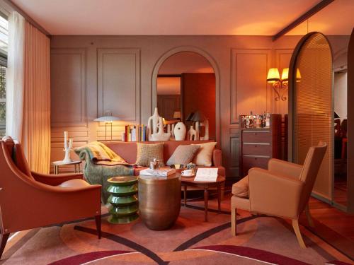 a living room with a couch and a table at Mondrian Bordeaux Les Carmes in Bordeaux