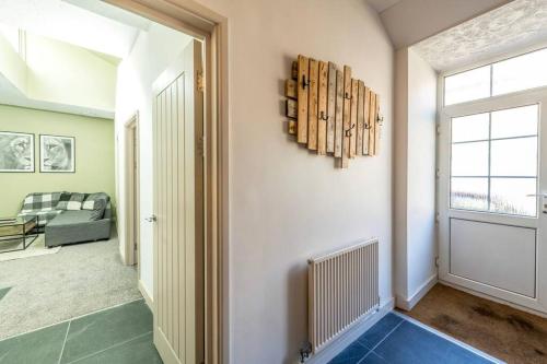 a hallway with a living room with a window at Newly Renovated Upnor House with 2 Free Parking by Prescott Apartments in Bristol