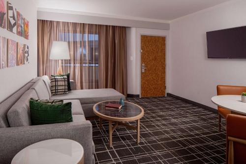 a living room with a couch and a table at Doubletree Suites by Hilton Salt Lake City in Salt Lake City