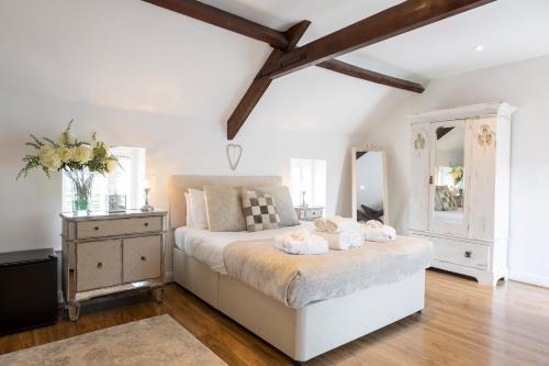 a bedroom with a bed with two towels on it at Westfield Granary in Ganton