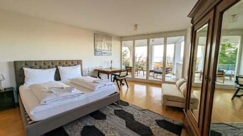 a bedroom with a bed and a living room at LIBORIA I Villa mit Seeblick 10min vom See in Herrsching am Ammersee