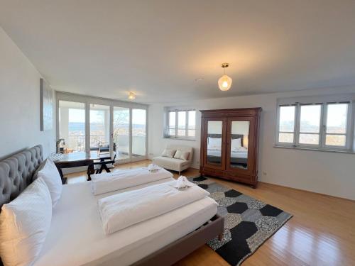 a large bedroom with two beds and a living room at LIBORIA I Villa mit Seeblick 10min vom See in Herrsching am Ammersee