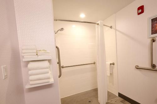 a bathroom with a shower and white towels at Hampton Inn Flemington in Flemington