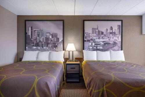 a room with two beds in a hotel room at Super 8 by Wyndham Owatonna in Owatonna