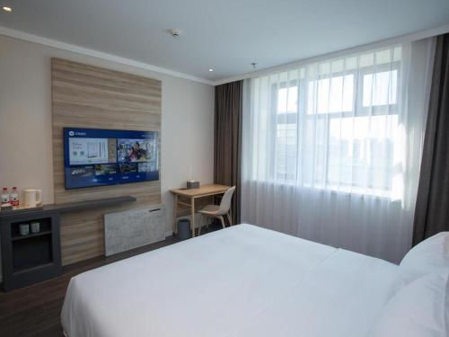 Voodi või voodid majutusasutuse Hanting Hotel Mudanjiang Dong'ertiao Road Pedestrain Street toas