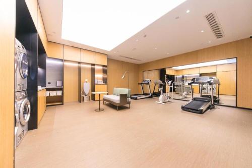 a gym with several treadmills and machines at Ji Hotel Zhenjiang Railway Station Nan Square in Zhenjiang