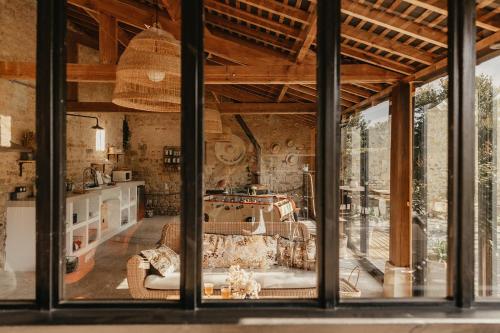 a view of a room with a large window at LE CLOS POULAIN Petits gîtes de charme et chambres d'hôtes Familiales au calme proche Bayeux et des plages in Nonant