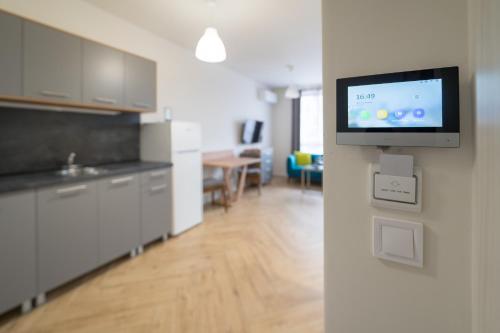 a kitchen with a flat screen tv on a wall at WOW studios for rent 2 bul Montevideo 25A - B in Sofia