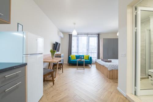 a kitchen and living room with a couch and a table at WOW studios for rent 2 bul Montevideo 25A - B in Sofia