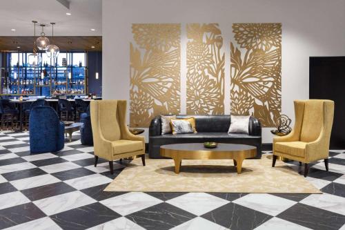 a lobby with a couch and chairs and a table at Legacy Hotel, Trademark Collection by Wyndham in Green Bay