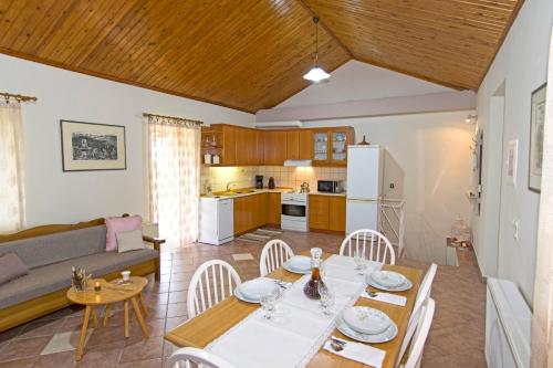 a kitchen and living room with a table and chairs at Aoria Traditional House in Loúlos