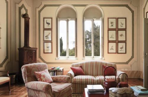 a living room with a couch and chairs and windows at Castello di Lispida in Monselice