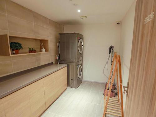 a kitchen with a refrigerator and a ladder in it at Hanting Premium Hotel Shanghai Puqingcheng Zhongxi Road in Qingpu