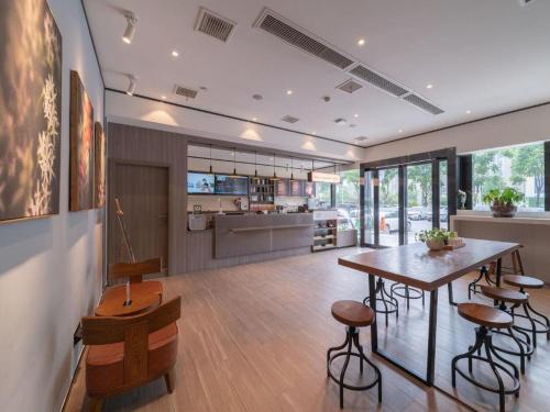 - une cuisine et une salle à manger avec une table et des chaises dans l'établissement Hanting Hotel Wuhan Shumin Zhijia, à Jiang'an