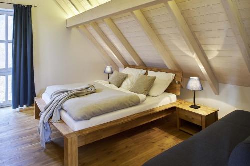 a bedroom with a large bed with a wooden headboard at Hexenhaus in Rietz Neuendorf