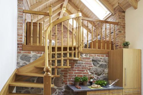 a wooden staircase in a room with a brick wall at Lindenhaus in Rietz Neuendorf