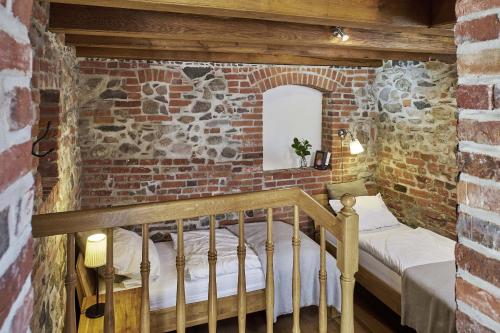 a bedroom with a bed in a brick wall at Lindenhaus in Rietz Neuendorf