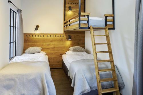two bunk beds in a room with a ladder at Tenne in Rietz Neuendorf