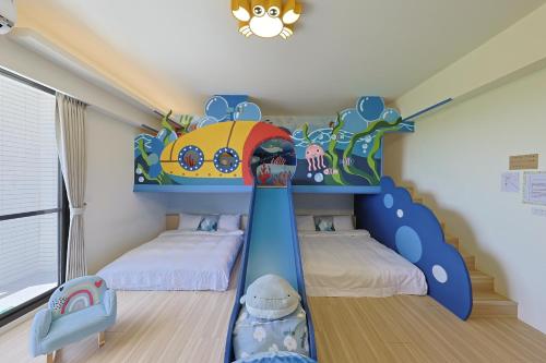 a childs bedroom with a train bunk bed at Bubble Forest in Taitung City