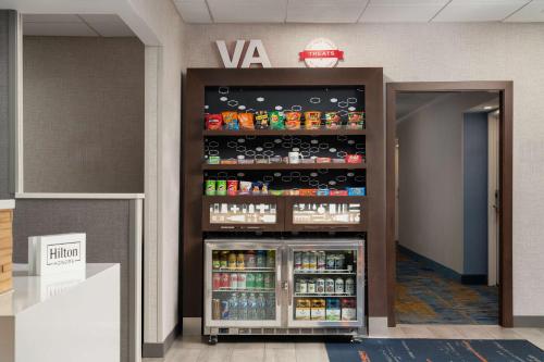 a soda vending machine in a building at Hampton Inn Fairfax City in Fairfax