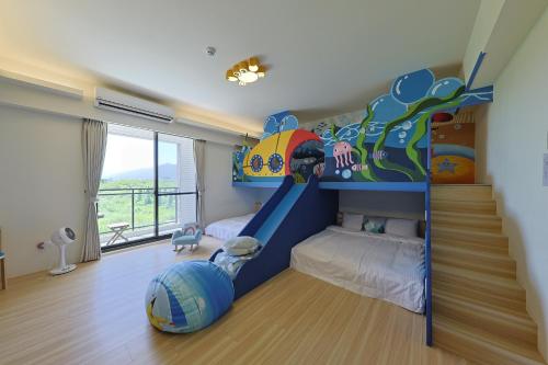 a kids room with a bunk bed and a staircase at Bubble Forest in Taitung City