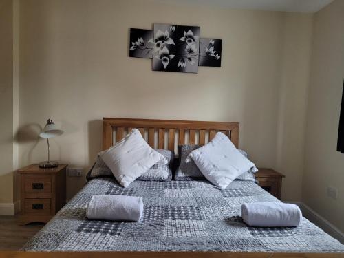 a bedroom with a bed with two pillows on it at Milton Court in Sittingbourne